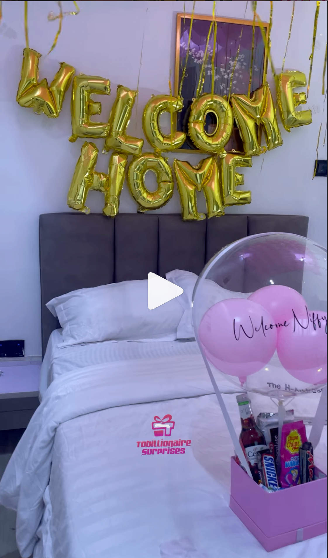 Welcome home surprise with gold balloons and gift box